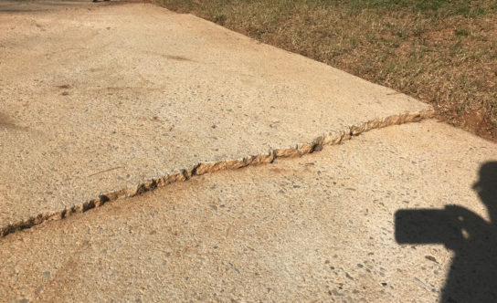 Cracks in concrete driveway of Triangle NC home before concrete lifting solution