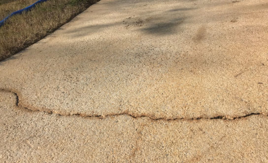 Cracks in concrete driveway of Triangle NC home before concrete lifting solution