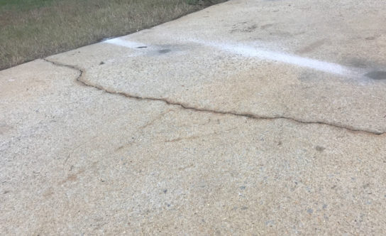 Cracks in concrete driveway of Cary NC home before concrete lifting solution