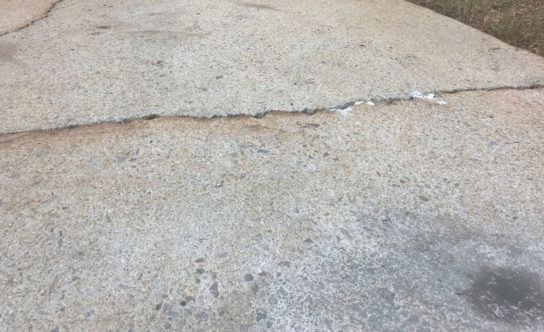 Cracks in concrete driveway of Cary NC home before concrete lifting solution