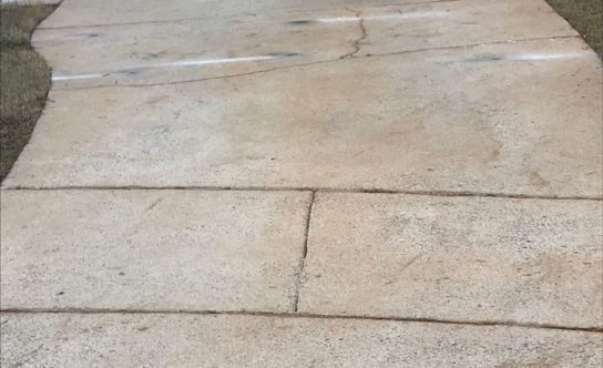 Cracks in concrete driveway of Apex NC home before concrete lifting solution