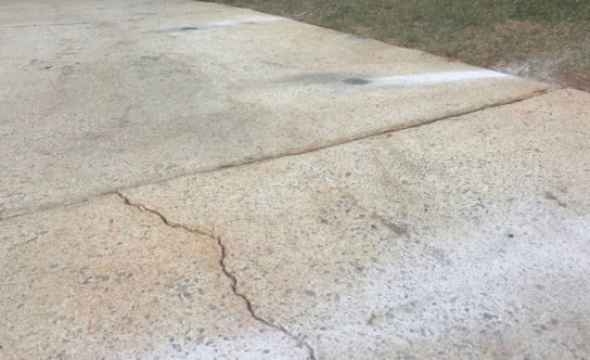 Cracks in concrete driveway of Morrisville NC home before concrete lifting solution
