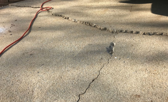 Cracks in concrete driveway of Knightdale NC home before concrete lifting solution
